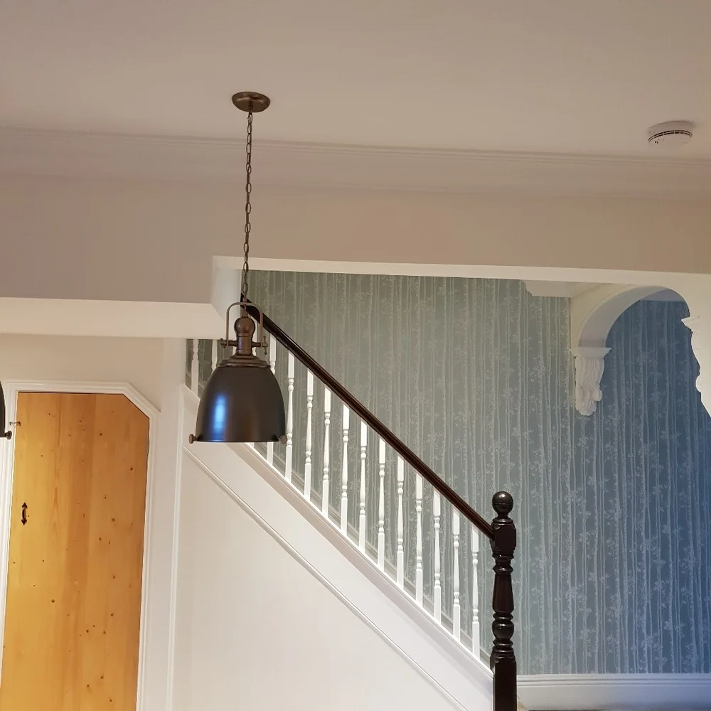 Wallpapered staircase and painted woodwork