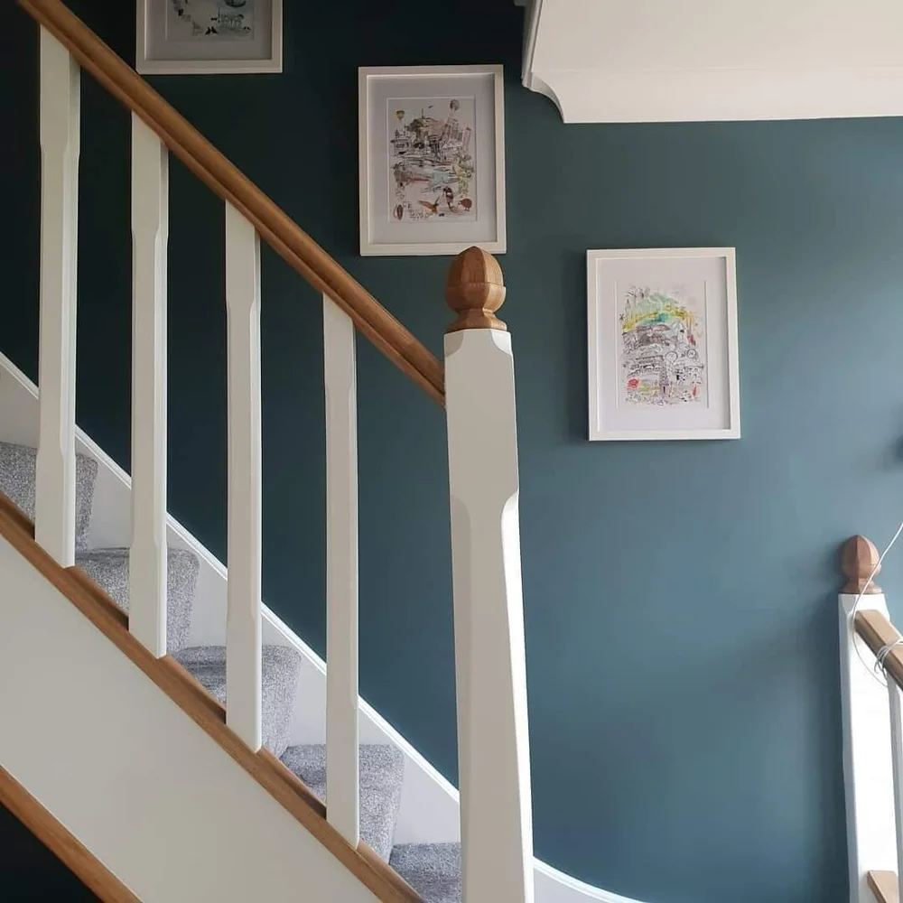 Decorated staircase with dark feature wall